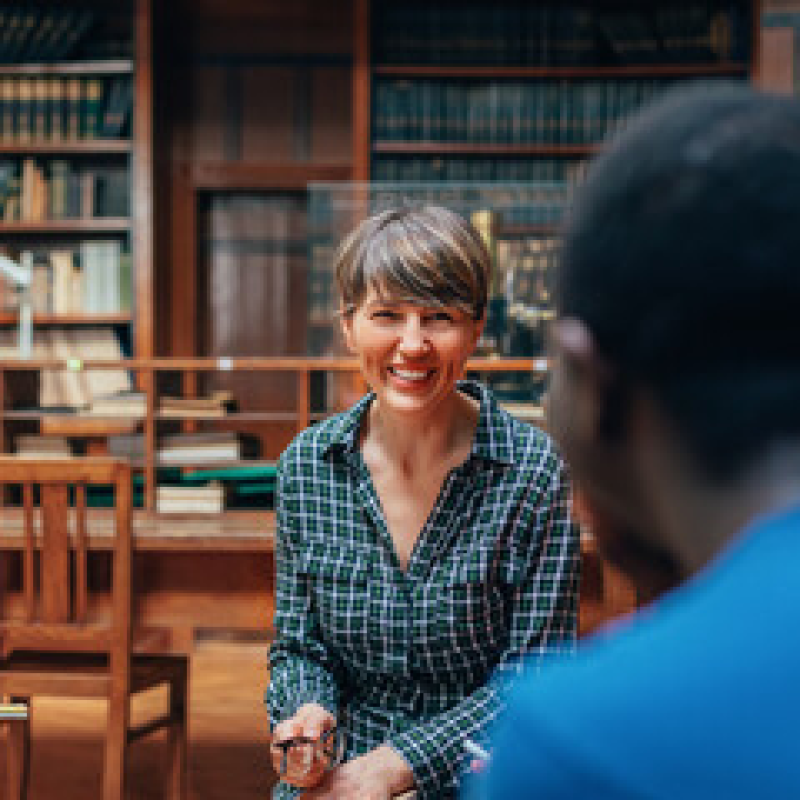A librarian helping somebody in a library