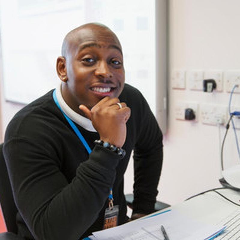 A professional staff member, smiling and ready to help