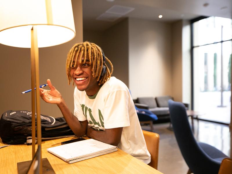 Student studying at a desk in the Southwest Campus Apartments